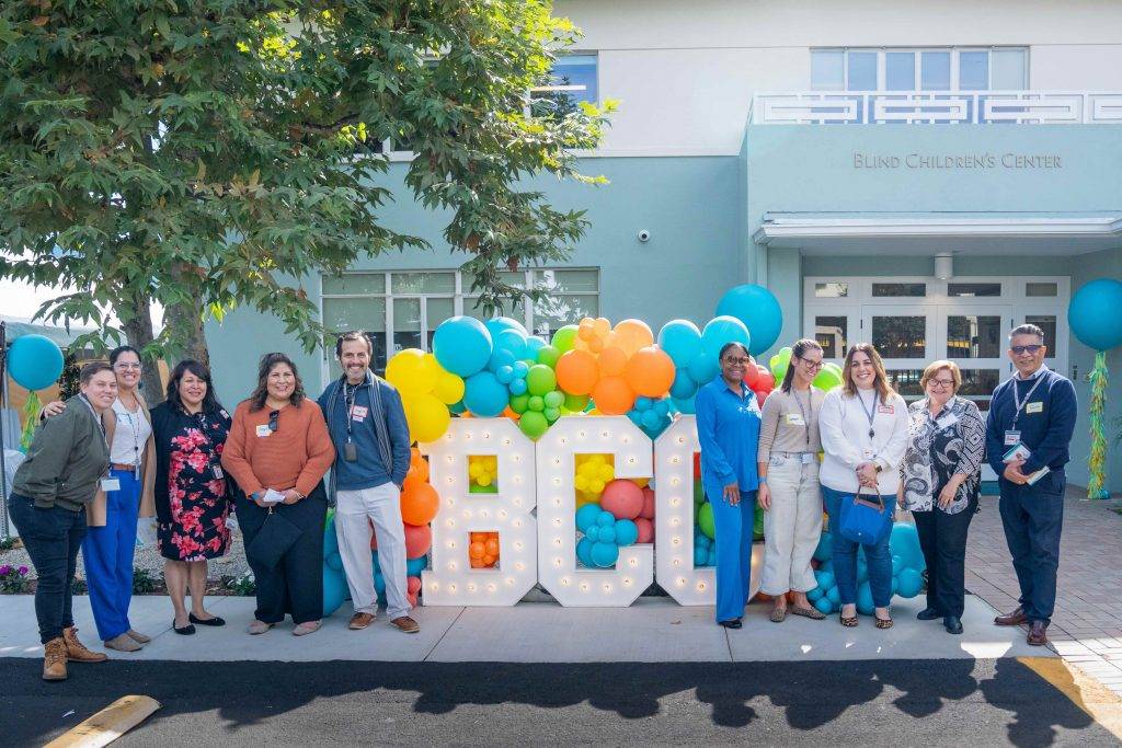 An image of the front of the Blind Children's Center's building shows a blue sign with silver lettering: "Blind Children's Center."